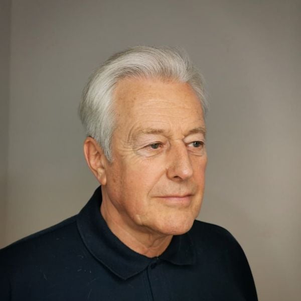 A man wearing polo shirt with older men hairstyle