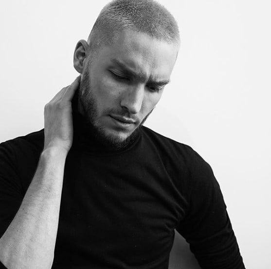 a man with Buzz Cut Men Haircuts for Men while wearing a black long sleeve