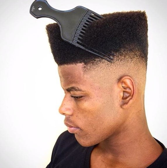 a man with High top style with a comb stuck on the hair
