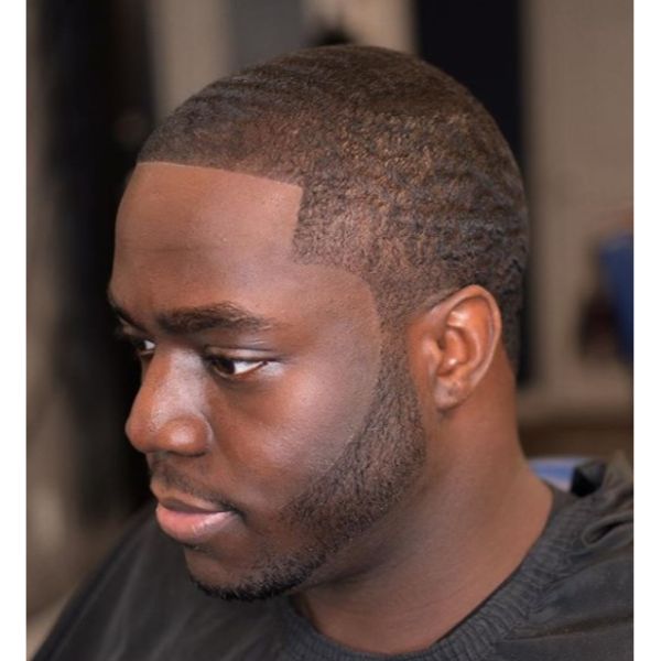 A man wearing black haircut cover