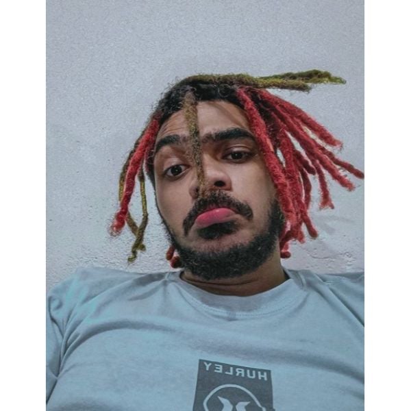 a man with Red and Green Medium Dreadlock Hairstyles For Men