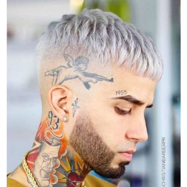 a man With Platinum Blonde Cropped Top with tattoos on the side of the head and neck - High Fade Haircuts For Men