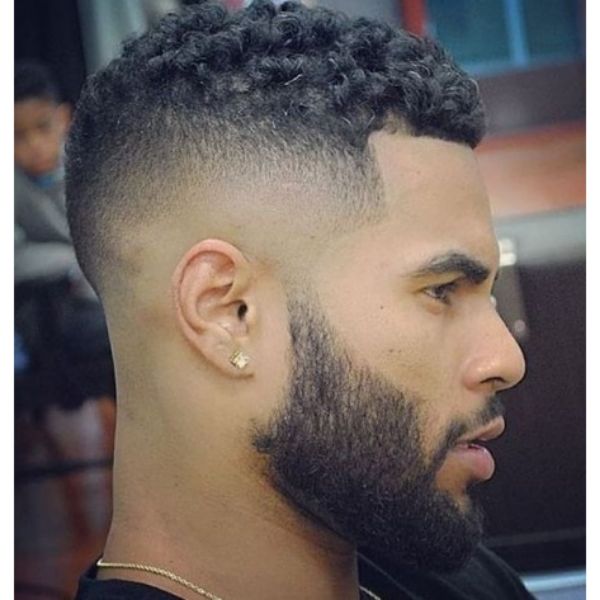 a man with Curly Top Hairstyle with bushy beard wearing an earring