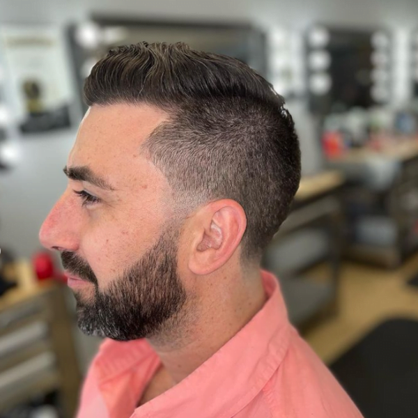 Man had his hair styled into Tapered Fade with Beard