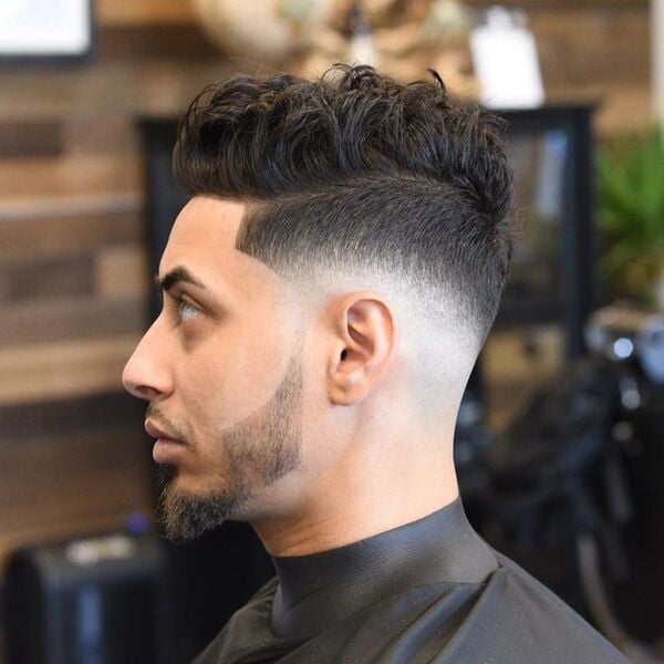 A Man with his  Tousled Mid Fade Haircut