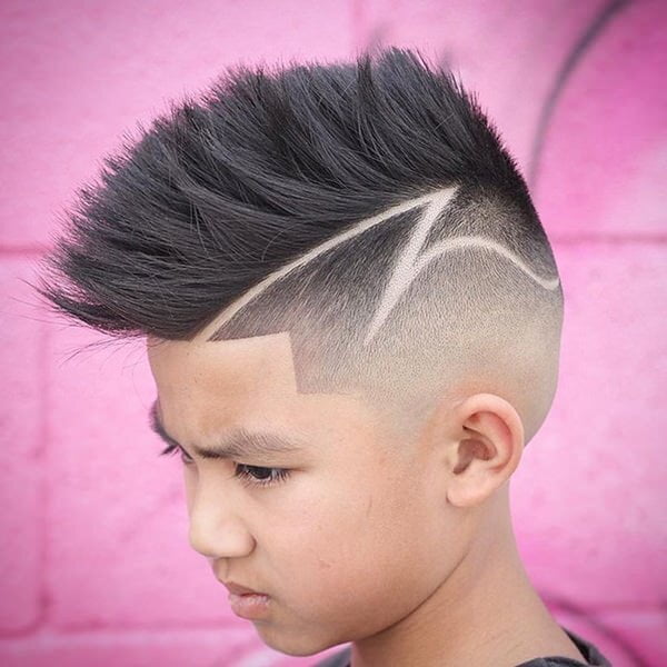 Young boy had his hair styled - Fade with Faux Hawk and Design