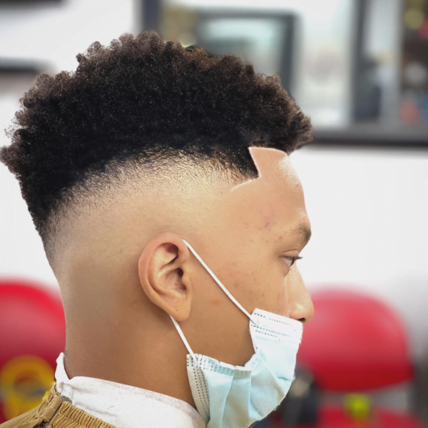 Man wearing mask had his hair styled into High Low Fade with Curly Hair